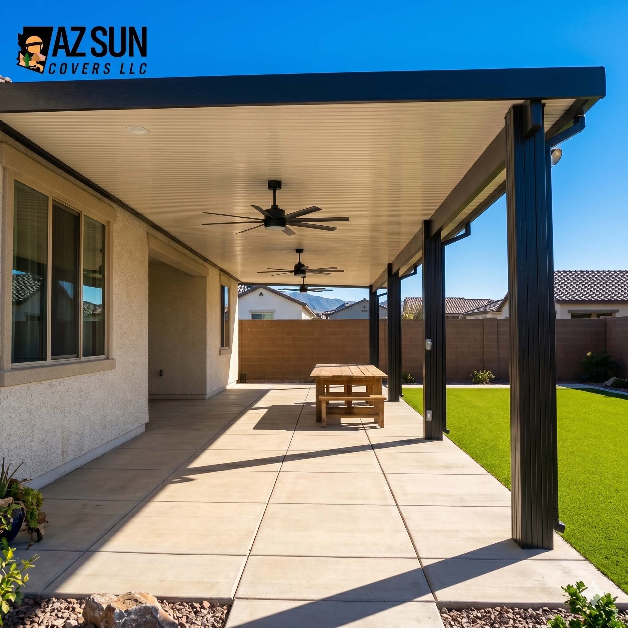 Attached solid patio cover with ceiling fans over concrete
