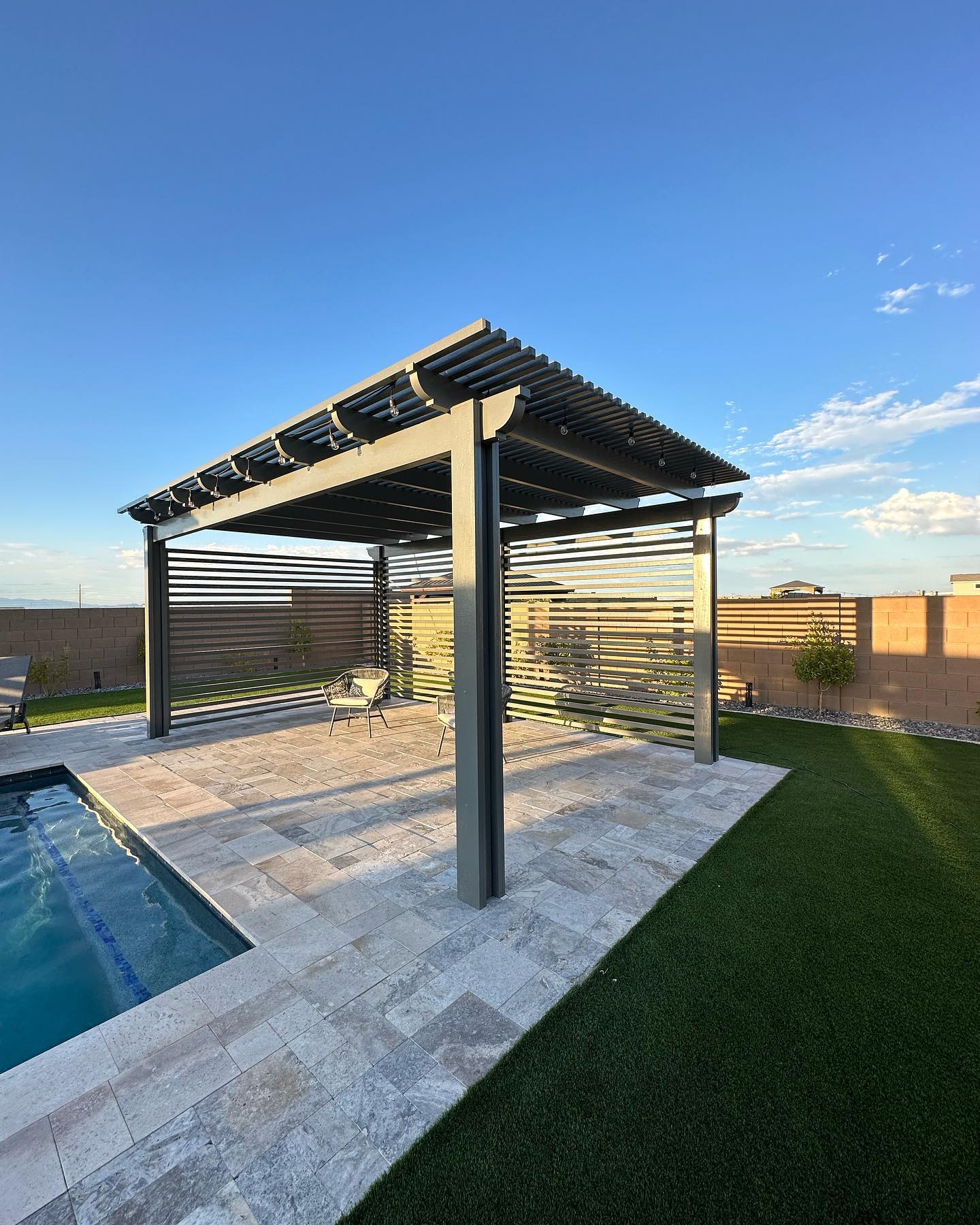 Louvered pergola over outdoor kitchen